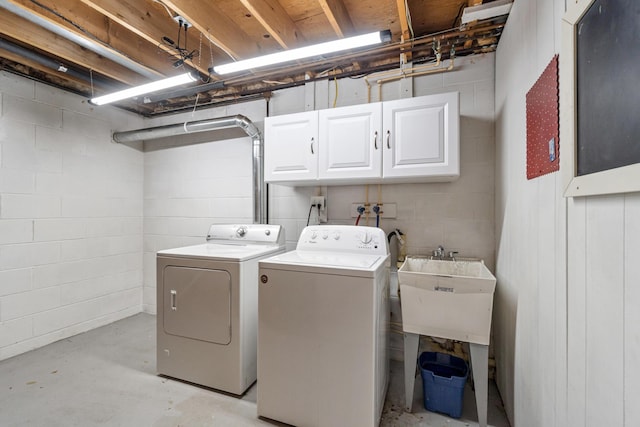 3125 Fawn Ln, Jackson, MI 49201 - laundry room featuring cabinet space, washer and dryer, and concrete block wall