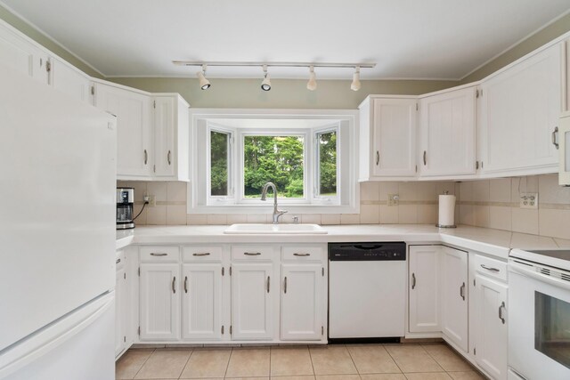 3125 Fawn Ln, Jackson, MI 49201 - kitchen featuring white appliances, white cabinets, track lighting, decorative backsplash, and light countertops