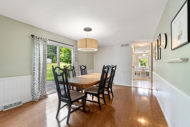 3125 Fawn Ln, Jackson, MI 49201 - dining area featuring light wood-type flooring, healthy amount of natural light, and a wainscoted wall