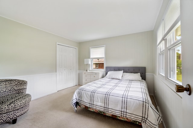 3125 Fawn Ln, Jackson, MI 49201 - bedroom featuring carpet floors, a closet, a wainscoted wall, and a decorative wall