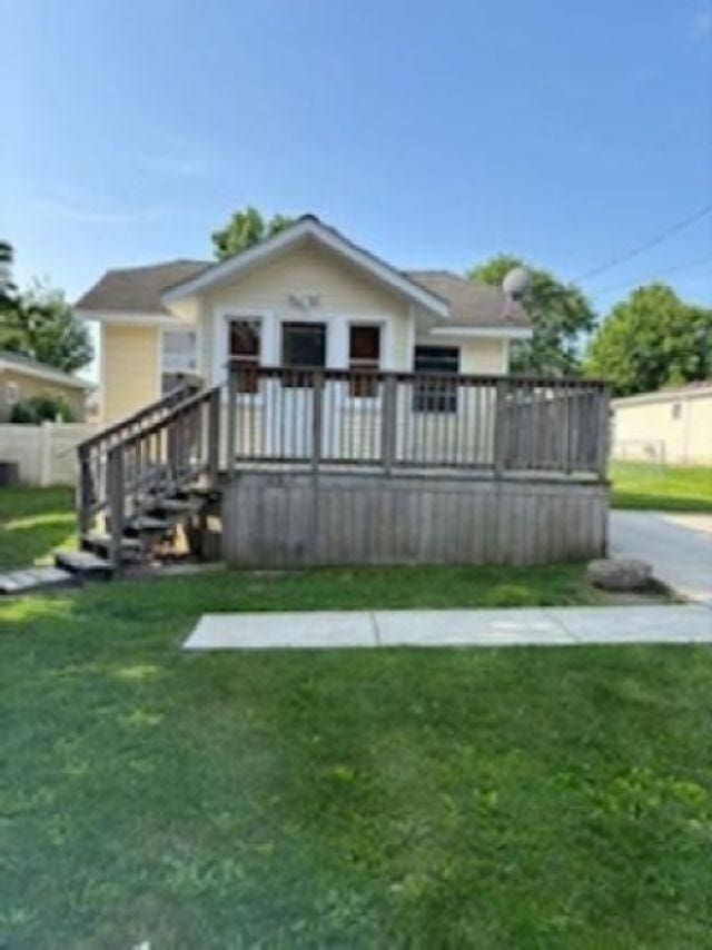 1431 Cleveland St, Owosso, MI 48867 - back of house featuring a lawn