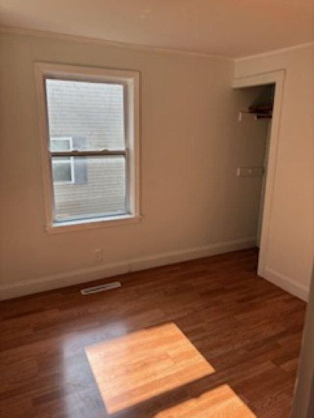 1431 Cleveland St, Owosso, MI 48867 - unfurnished bedroom with wood finished floors and ornamental molding