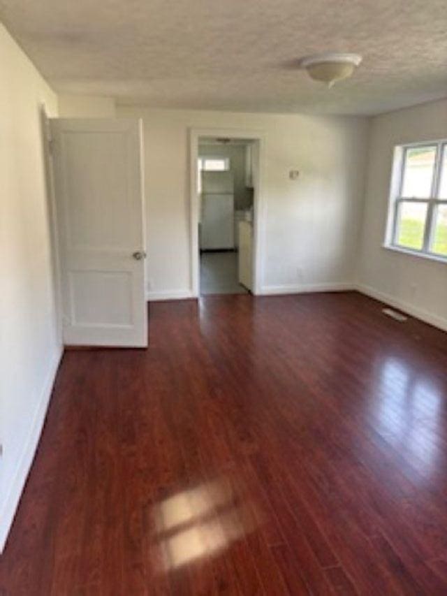1431 Cleveland St, Owosso, MI 48867 - spare room with wood finished floors and a textured ceiling