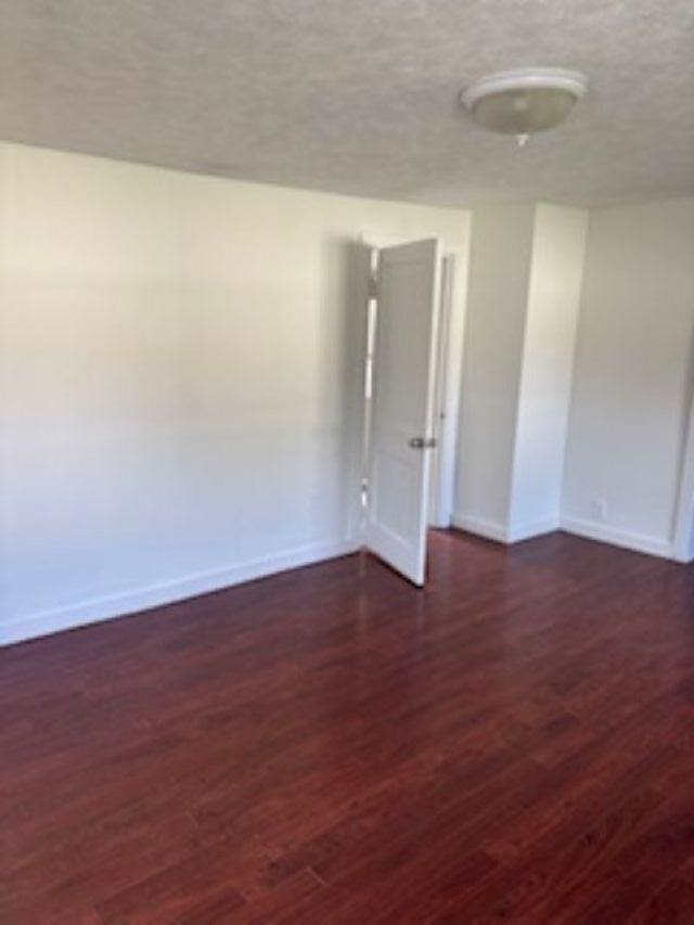 1431 Cleveland St, Owosso, MI 48867 - empty room with wood finished floors and a textured ceiling