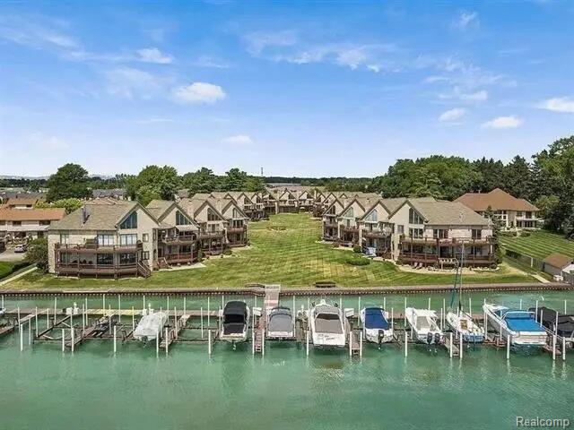 50703 Harbour View Dr N, New Baltimore, MI 48047 - back of property with boat lift, a yard, and a residential view