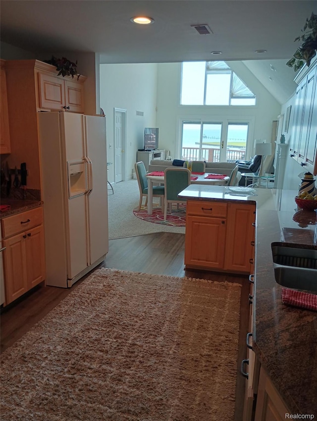 50703 Harbour View Dr N, New Baltimore, MI 48047 - kitchen with white fridge with ice dispenser, light wood finished floors, open floor plan, light brown cabinetry, and lofted ceiling