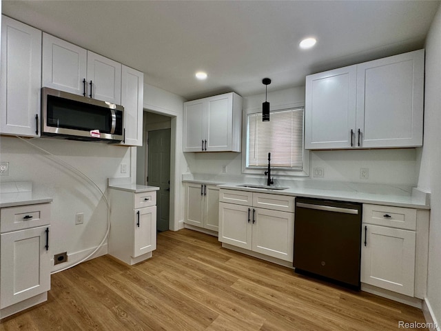 297 W Yale Ave, Pontiac, MI 48340 - kitchen featuring stainless steel appliances, white cabinets, light countertops, light wood finished floors, and recessed lighting