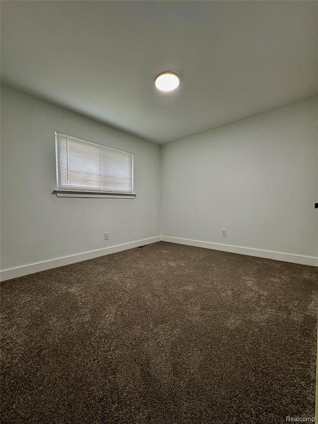 297 W Yale Ave, Pontiac, MI 48340 - spare room with dark colored carpet and baseboards