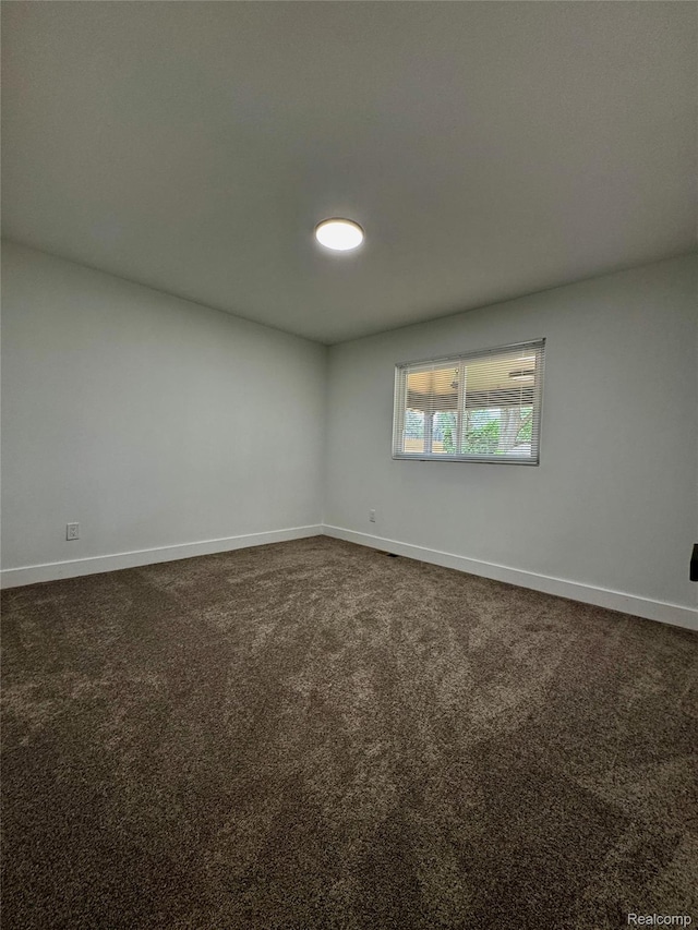 297 W Yale Ave, Pontiac, MI 48340 - spare room with baseboards and dark colored carpet