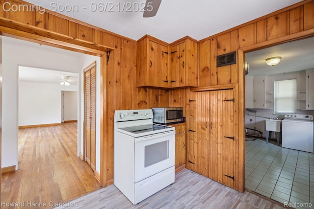 5766 Corunna Ave, Clarkston, MI 48346 - kitchen featuring white electric range, stainless steel microwave, a ceiling fan, light wood-style floors, and brown cabinetry