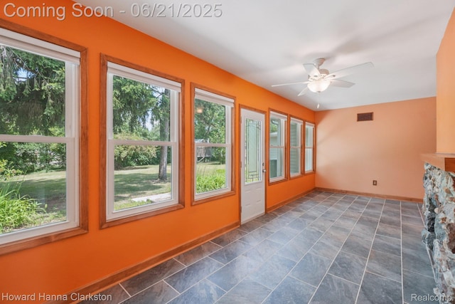5766 Corunna Ave, Clarkston, MI 48346 - unfurnished sunroom featuring baseboards and stone finish floors
