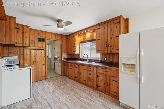 5766 Corunna Ave, Clarkston, MI 48346 - kitchen featuring white fridge with ice dispenser, washer / clothes dryer, and brown cabinets