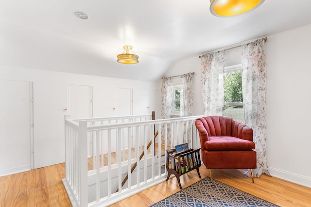 317 Cherry St, South Haven, MI 49090 - sitting room with an upstairs landing, vaulted ceiling, and wood finished floors