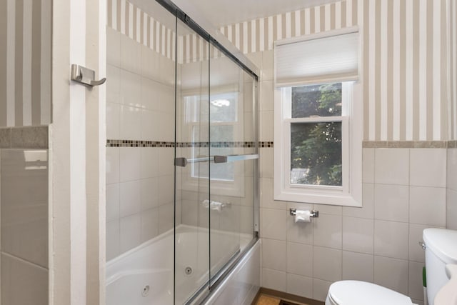 317 Cherry St, South Haven, MI 49090 - bathroom with tile walls, wallpapered walls, and a combined bath / shower with jetted tub