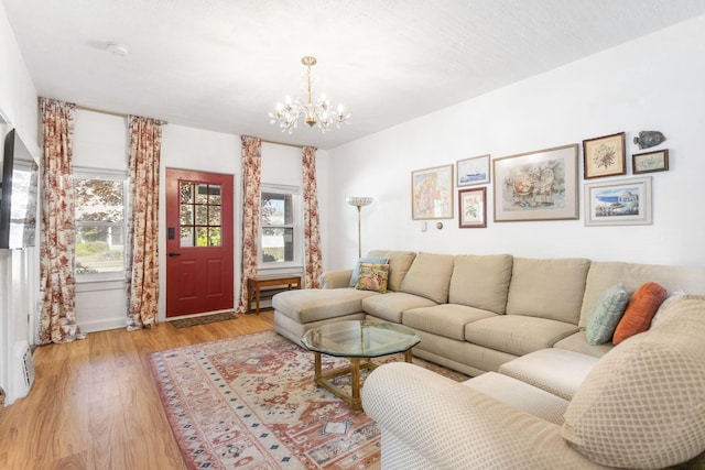 317 Cherry St, South Haven, MI 49090 - living room featuring a chandelier and light wood-type flooring