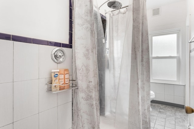 317 Cherry St, South Haven, MI 49090 - bathroom with a tile shower and tile walls