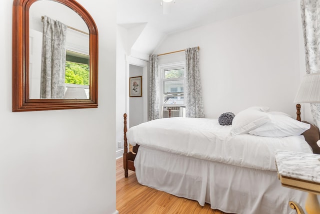 317 Cherry St, South Haven, MI 49090 - bedroom with wood finished floors, cooling unit, vaulted ceiling, and a ceiling fan