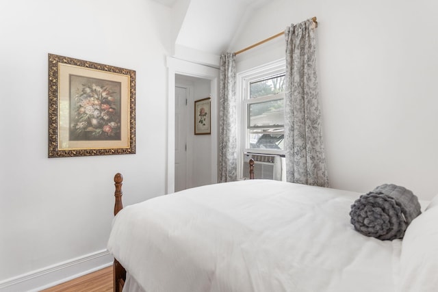 317 Cherry St, South Haven, MI 49090 - bedroom with cooling unit, vaulted ceiling, and wood finished floors