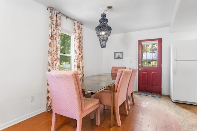 317 Cherry St, South Haven, MI 49090 - dining space with a chandelier and light wood-type flooring