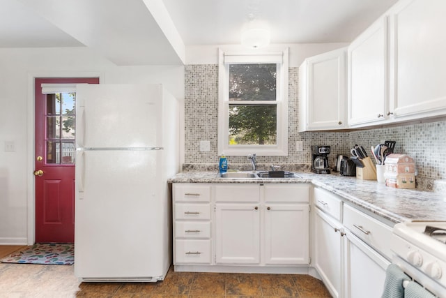 317 Cherry St, South Haven, MI 49090 - kitchen with white appliances, decorative backsplash, white cabinetry, and light stone counters