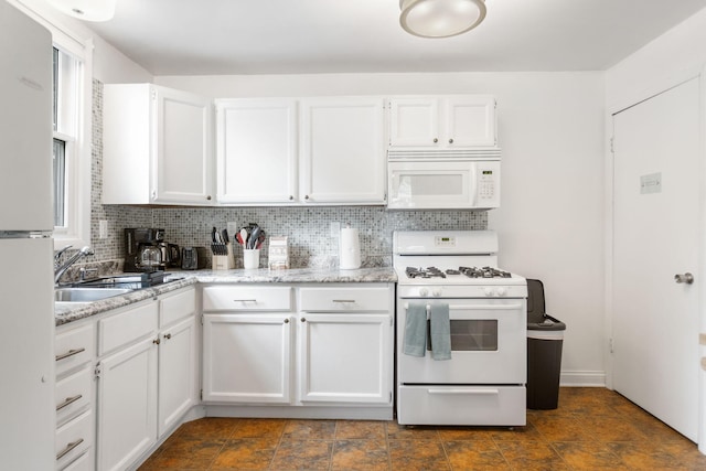 317 Cherry St, South Haven, MI 49090 - kitchen with white appliances, tasteful backsplash, and white cabinetry