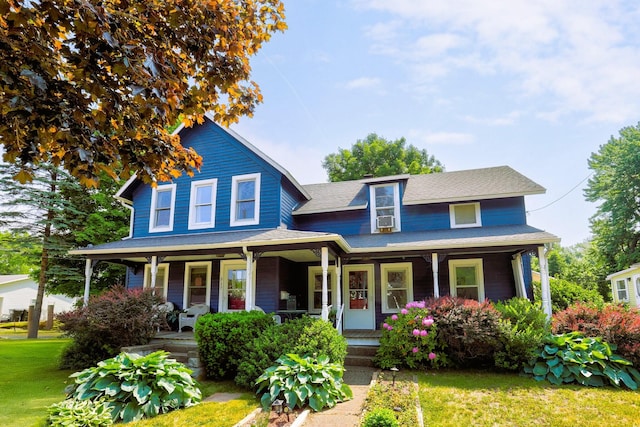 317 Cherry St, South Haven, MI 49090 - view of front of home with covered porch, a front lawn, a shingled roof, and cooling unit
