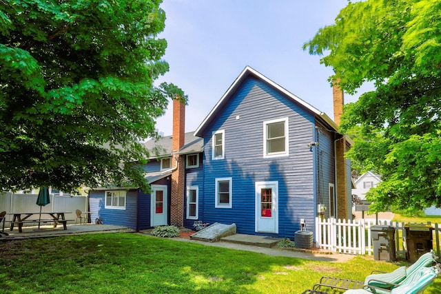 317 Cherry St, South Haven, MI 49090 - back of house featuring a chimney and a patio