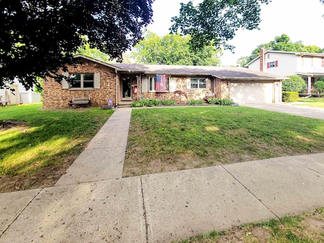 424 Leland St, Flushing, MI 48433 - view of front of property with an attached garage, a front yard, driveway, and brick siding