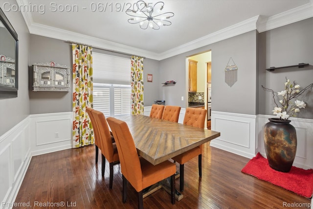 51159 Luke Ln, Novi, MI 48374 - dining room with crown molding, a chandelier, dark wood-type flooring, a decorative wall, and a wainscoted wall