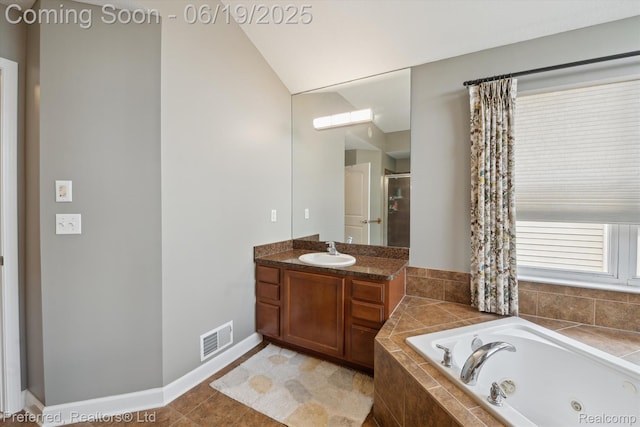 51159 Luke Ln, Novi, MI 48374 - bathroom with a tub with jets, vanity, a shower, lofted ceiling, and tile patterned floors
