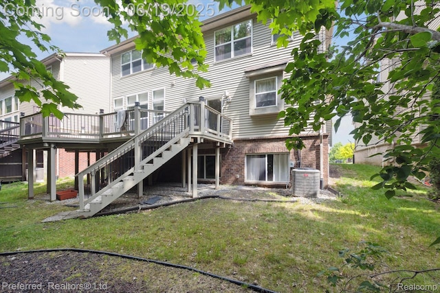 51159 Luke Ln, Novi, MI 48374 - back of property featuring stairs, a deck, brick siding, and a lawn