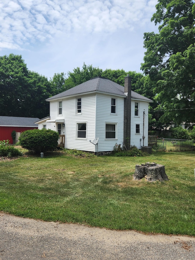 222 Scribner St, Delton, MI 49046 - view of home's exterior featuring a chimney and an outdoor fire pit