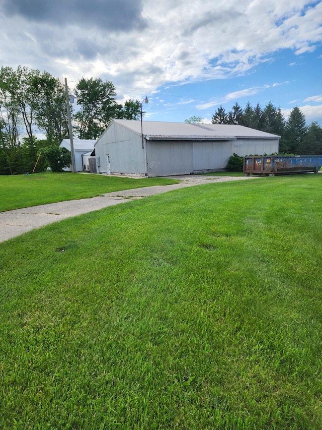 10510 S Hemlock, Brant, MI 48614 - view of side of property with a pole building, a yard, and an outdoor structure