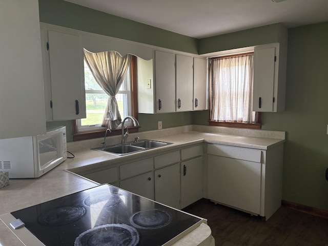 10510 S Hemlock, Brant, MI 48614 - kitchen with white microwave, light countertops, white cabinets, stove, and dark wood-style floors