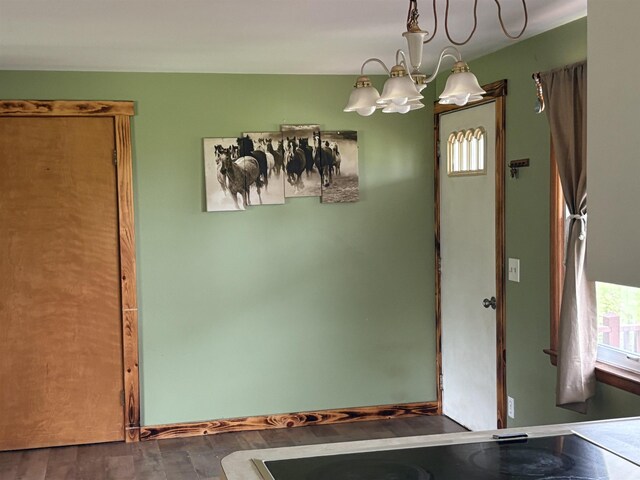 10510 S Hemlock, Brant, MI 48614 - unfurnished dining area featuring a chandelier and dark wood finished floors