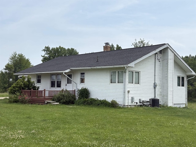 10510 S Hemlock, Brant, MI 48614 - rear view of house featuring a chimney, a yard, a wooden deck, and a shingled roof