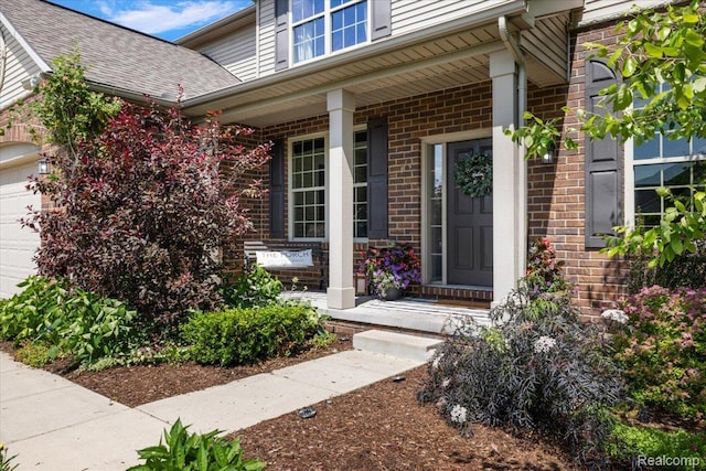 966 Wynstone Cir N, Oakland, MI 48363 - property entrance with a porch, brick siding, an attached garage, and a shingled roof
