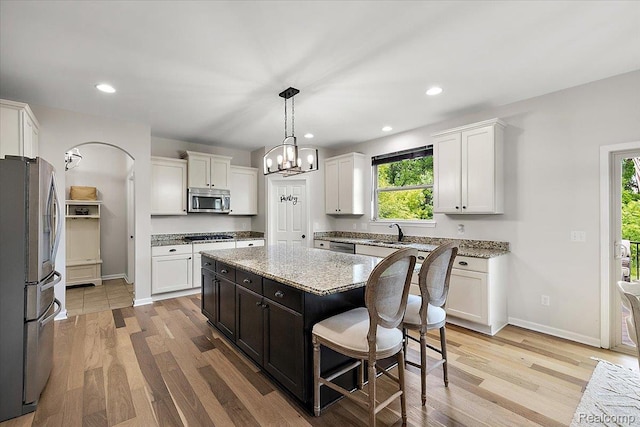966 Wynstone Cir N, Oakland, MI 48363 - kitchen with stainless steel appliances, light wood finished floors, white cabinets, and recessed lighting