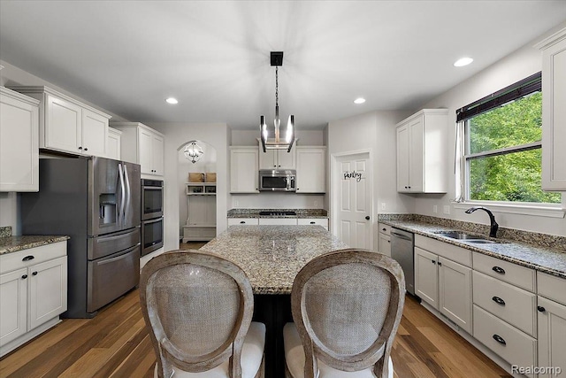 966 Wynstone Cir N, Oakland, MI 48363 - kitchen featuring stainless steel appliances, dark wood-style flooring, light stone counters, white cabinets, and recessed lighting