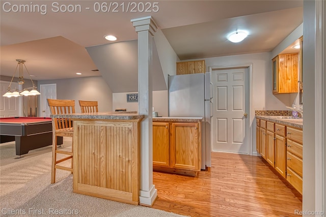 1070 Pointe Place Ct, Rochester, MI 48307 - kitchen featuring a breakfast bar area, light wood-style flooring, hanging light fixtures, freestanding refrigerator, and pool table