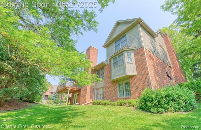 1070 Pointe Place Ct, Rochester, MI 48307 - back of house with a chimney, brick siding, a yard, and a deck