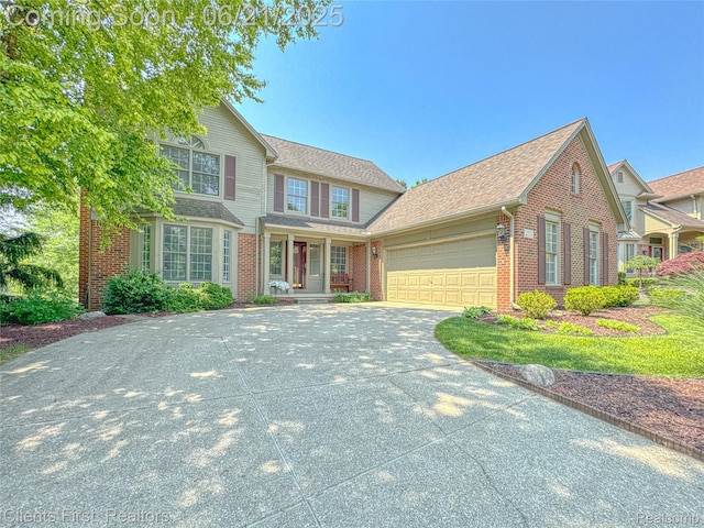 1070 Pointe Place Ct, Rochester, MI 48307 - traditional-style home featuring brick siding, an attached garage, concrete driveway, a porch, and roof with shingles
