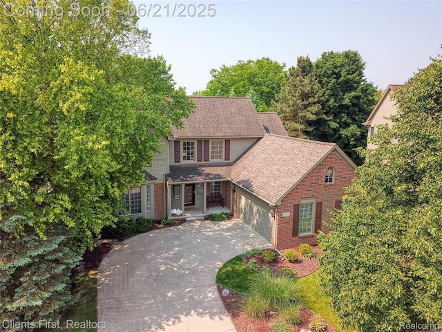 1070 Pointe Place Ct, Rochester, MI 48307 - view of front of property with brick siding, driveway, an attached garage, and roof with shingles