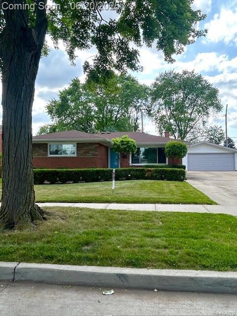 30821 Longfellow Ave, Madison Heights, MI 48071 - single story home with a front lawn, a detached garage, and brick siding