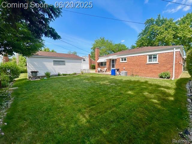 30821 Longfellow Ave, Madison Heights, MI 48071 - rear view of house with a lawn and brick siding