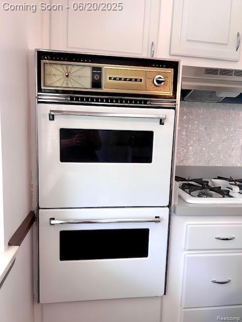 30821 Longfellow Ave, Madison Heights, MI 48071 - kitchen view of under cabinet range hood, white appliances, and white cabinetry