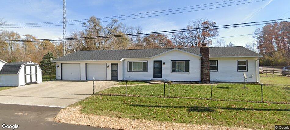 275 Pawnee St, Battle Creek, MI 49014 - ranch-style house with a storage unit, a garage, driveway, and a chimney