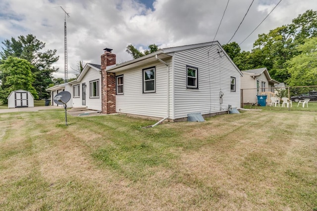 275 Pawnee St, Battle Creek, MI 49014 - view of side of home featuring a shed and a chimney