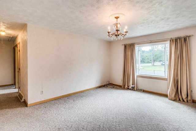275 Pawnee St, Battle Creek, MI 49014 - spare room featuring carpet floors, a textured ceiling, attic access, and a chandelier