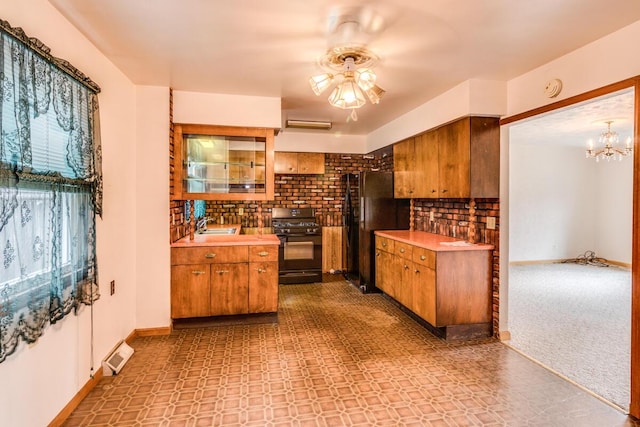 275 Pawnee St, Battle Creek, MI 49014 - kitchen featuring black appliances, brown cabinetry, decorative backsplash, and light countertops